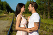 © Евгения Медведева - loving couple walking along train rails on a sunny day
