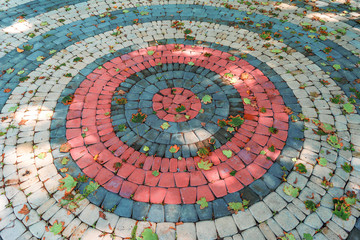 a mosaic of paving stones.multi-colored paving stone laid out in a circle