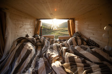 Interior Of Camper Van With Cozy Bed During Summer Sunset