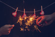 Couple holding a burning sparklers with valentine background concept.