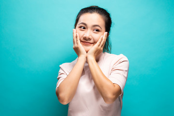 Happy woman standing isolated over blue background