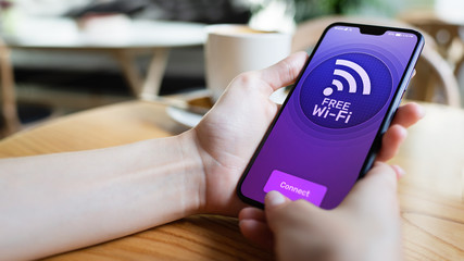 Free wifi connection on mobile phone screen. Internet and telecommunication technology concept.