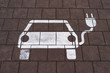 Ladeplatz / Elektro-Auto Piktogramm auf Pflastersteinen