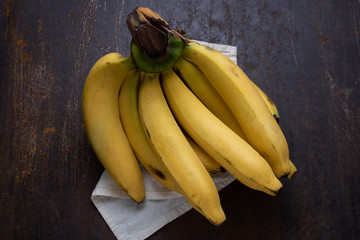 Yellow ripe banana on rustic metal floor