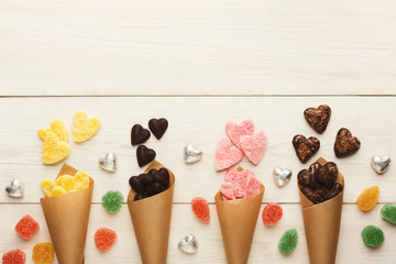 Wall Mural - Lovers day background with various sweets in craft cornets