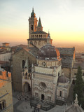 Fototapeta  - Bergamo, Italy. The old town. Aerial view of the Basilica of Santa Maria Maggiore and the chapel Colleoni during the sunset