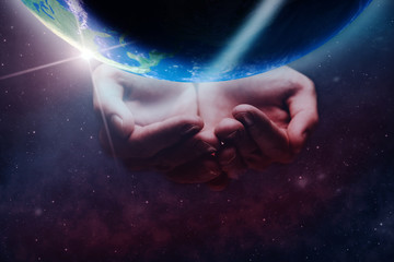 Leinwandbilder - Protect our world in human hands and nebula dust. Mixed media .Elements of this image furnished by NASA.