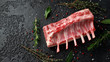 © grinchh - raw fresh rack of lamb with green herbs.