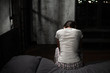© Damir Khabirov - Female sitting helplessly in bedroom at night trying to get out of her troubles