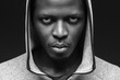 African criminal concept. Portrait of bad guy with thug life, weating hoodie, looking at camera