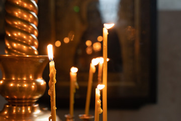 the flame of Church candles lit in the Church