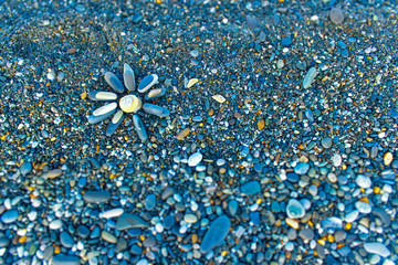 Sun made of stones on the beach. Top view.