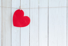 Red Heart Hanging On White Wood  Background With Copy Space.
