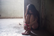Depressed hostage girl tied by rope
