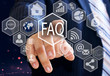 © Stanislau_V - The businessman chooses  FAQ  button on the touch screen with a futuristic background .The concept FAQ  .