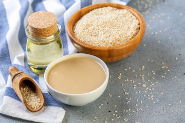 Wall Mural - Bottled sesame oil, tahini and white sesame seeds.