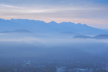 Top View Misty Morning Above Mae Hong Son City, View Of The Sea Of Mist Moving Above City Around With Mountain And Cloudy Sky Background, Sunrise At Wat Phra That Doi Kong Mu, Mae Hong Son Thailand.