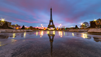 Sunrise on the Eiffel tower reflection on the Trocadero fountain water in Paris, one of the most visited building by the tourists