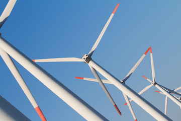 angled view of wind turbines against a blue sky