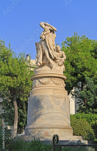 Fotografie, Obraz Public XIX century sculpture of the famous British poet Lord Byron crowned by personification of Greece in the National Garden in Athens, Greece with blue sky copy space