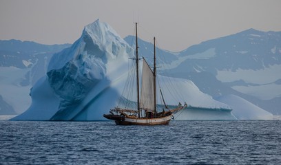 two mast classic sailing boat among arctic snow covered landscape