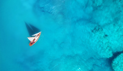 Wall Mural - yacht on the water surface from top view. turquoise water background from top view. summer seascape 