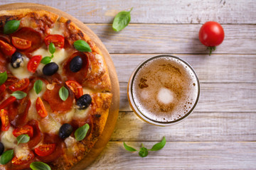 Wall Mural - Beer and pizza on wooden plate. Ale and  snack. Overhead, horizontal