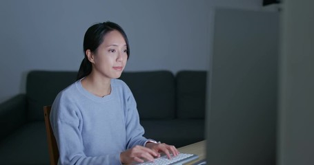 Wall Mural - Woman work on computer at home in the evening