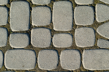 Asymmetric paving slabs of gray color, different size. Background