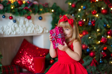 Little girl decorating christmas tree. Christmas. New Year. Christmas eve. Holiday. Indoor. Home.