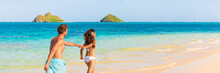 Beach Summer Vacation Happy Young Tourists Lovers On Hawaii Vacation Travel. Man And Woman Holding Hands In The Sun. Landscape Panoramic Banner People Lifestyle.