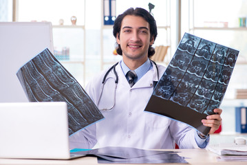 Young handsome male radiologist in front of whiteboard 