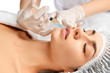 © Dmitry Lobanov - Plastic lips surgery beauty concept young brunette woman face and  doctor hand in glove with syringe