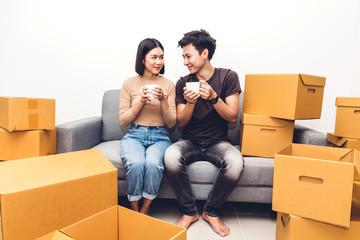 Wall Mural - Happy young couple unpacking box and moving into their new home.House moving and real estate concept