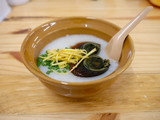 Fototapeta  - Rice porridge with century egg and ginger in a bowl on wooden background