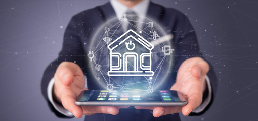 Poster - Businessman holding Smart home interface with icon, stats and data 3d rendering