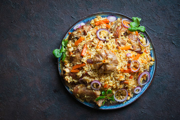 Wall Mural - Uzbek plov  a rice dish prepared with lamb,  stewed with fried onions, garlic and carrots rice,  dried fruits,  garlic and cumin.