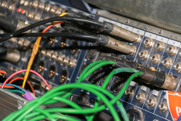 Close up of jack cable connected at rear of switcher sound mixer control panel