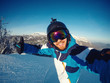 Selfie Guy sportsman goes on normal skiing on ski slope with action camera. Sunset. winter