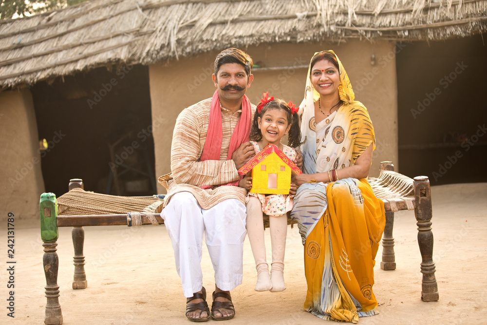 Rural Indian family holding dream house model Stock Photo | Adobe Stock