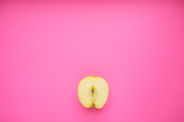 Wall Mural - Cut apple on pink background, top view copy space