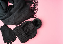 Flat Lay Winter Or Autumn Warm Woman Accessories - Black Knitted Scarf, Hat On Bright Pink Background, Copy Space