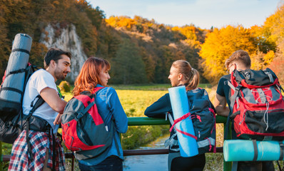 Wall Mural - group of friends during a tourist trip with backpacks