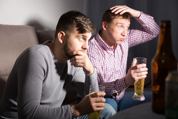 Wall Mural - Frustrated men watching matchup on tv