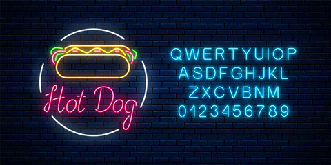 Wall Mural - Neon hot dog cafe glowing signboard with alphabet on a dark brick wall background. Fastfood light billboard sign.