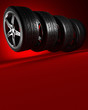 3d illustration. Four car wheels on red background. Poster or cover design.