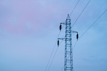 Electric pylon with a power line in the sunset