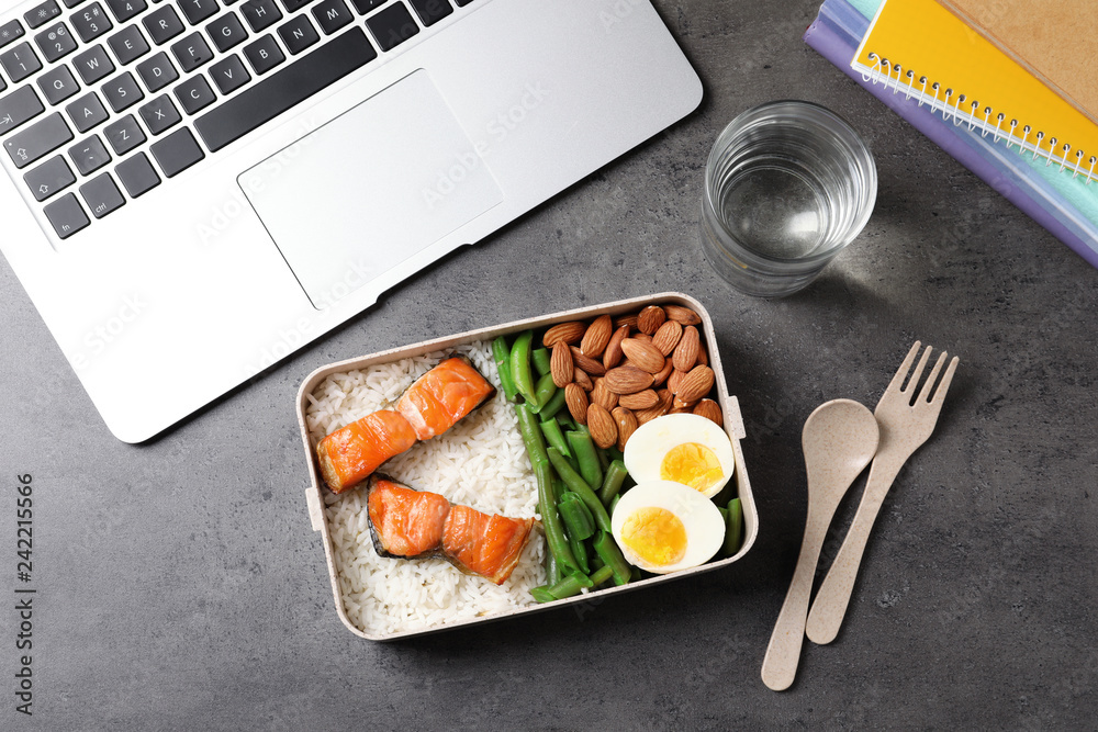 Flat lay composition with container of natural protein food on office table