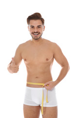 Sticker - Fit man measuring his waist on white background. Weight loss