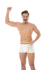 Sticker - Fit man measuring his waist on white background. Weight loss